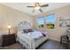 Charming bedroom with a queen bed and window views at 16866 S 180Th Ave, Goodyear, AZ 85338
