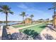 Well-maintained bocce ball courts near a lake at 16866 S 180Th Ave, Goodyear, AZ 85338