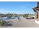 Landscaped backyard with pond and seating area at 16866 S 180Th Ave, Goodyear, AZ 85338