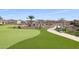 Landscaped putting green with a winding path and bench at 16866 S 180Th Ave, Goodyear, AZ 85338