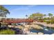 Picturesque red footbridge over a tranquil waterway at 16866 S 180Th Ave, Goodyear, AZ 85338