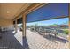 Covered patio with seating area and view of a pond at 16866 S 180Th Ave, Goodyear, AZ 85338