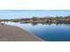 Serene lakefront property with clear water and surrounding homes at 16866 S 180Th Ave, Goodyear, AZ 85338