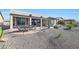 Spacious backyard with covered patio, desert landscaping, and fire pit at 16866 S 180Th Ave, Goodyear, AZ 85338
