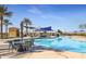 Community pool with shaded seating areas and palm trees at 16866 S 180Th Ave, Goodyear, AZ 85338