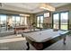Game room with two billiard tables and access to a patio at 16866 S 180Th Ave, Goodyear, AZ 85338