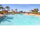 Resort-style community pool with palm trees and clear water at 16866 S 180Th Ave, Goodyear, AZ 85338