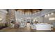 Spacious living room with high ceilings, stone fireplace, and hardwood floors at 9290 E Thompson Peak Pkwy # 493, Scottsdale, AZ 85255