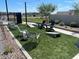 Community lawn area with cornhole and seating at 2646 E Bluff Spring Ave, Apache Junction, AZ 85119