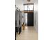 Elegant entryway with modern chandelier, wood floors, and black door at 6525 E Cave Creek Rd # 6, Cave Creek, AZ 85331