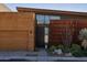 Modern home with wood and metal siding, attached garage, and desert landscaping at 6525 E Cave Creek Rd # 6, Cave Creek, AZ 85331