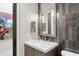 Stylish bathroom with a single vanity and dark tile accents at 6525 E Cave Creek Rd # 6, Cave Creek, AZ 85331