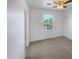 Well-lit bedroom featuring a window with blinds and carpet flooring at 1842 N 77Th Gln, Phoenix, AZ 85035