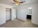Bright bedroom with ceiling fan and ensuite bathroom access at 1842 N 77Th Gln, Phoenix, AZ 85035