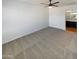 Spacious bedroom with neutral carpeting and ceiling fan at 1842 N 77Th Gln, Phoenix, AZ 85035