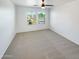 Spacious bedroom with two windows and a ceiling fan at 1842 N 77Th Gln, Phoenix, AZ 85035