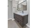 Modern bathroom with floating vanity and a large mirror at 7955 E Solano Dr, Scottsdale, AZ 85250