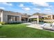 Modern home exterior with a lush green lawn and pool at 13463 N Stone View Trl, Fountain Hills, AZ 85268