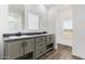 Bathroom with double sinks, dark countertop, and large mirror at 8066 N Palo Verde Rd, Florence, AZ 85132