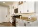 White shaker cabinets, granite countertops and stainless steel appliances in this kitchen at 1004 E Tempe Dr, Tempe, AZ 85281