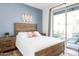 Bedroom with wood bed frame and access to backyard at 1004 E Tempe Dr, Tempe, AZ 85281