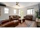 Bright and airy living room with leather sofas and access to a balcony at 1004 E Tempe Dr, Tempe, AZ 85281