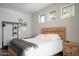 Bright bedroom with wooden bed frame and neutral decor at 1004 E Tempe Dr, Tempe, AZ 85281