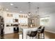 Modern kitchen with white cabinets, granite countertops and a curved breakfast bar at 1004 E Tempe Dr, Tempe, AZ 85281