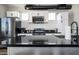 Sleek kitchen boasting black countertops and white cabinetry at 1004 E Tempe Dr, Tempe, AZ 85281
