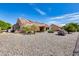 Spacious backyard with gravel, solar panels, and mature plants at 14109 W Horizon Dr, Sun City West, AZ 85375