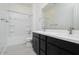 Double sink bathroom with dark vanity, shower, and tub at 3636 W Summerside Rd, Laveen, AZ 85339