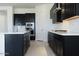 Modern kitchen with dark cabinetry, white quartz countertops, and herringbone backsplash at 3636 W Summerside Rd, Laveen, AZ 85339