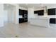 Open-concept kitchen and living area with light wood-look tile flooring at 3636 W Summerside Rd, Laveen, AZ 85339