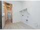 Laundry room with built-in shelving and tile floors at 3636 W Summerside Rd, Laveen, AZ 85339