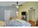 Main bedroom with high ceilings, neutral color tones, and a ceiling fan at 2416 W Caribbean Ln # 1, Phoenix, AZ 85023