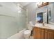 Clean bathroom with a tub/shower combo and wood vanity at 2416 W Caribbean Ln # 1, Phoenix, AZ 85023