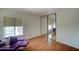 Spacious bedroom with mirrored closet doors and a purple sofa at 2416 W Caribbean Ln # 1, Phoenix, AZ 85023