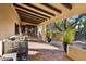 Covered entryway with terracotta tile flooring and wooden door at 3044 Ironwood Rd, Carefree, AZ 85377
