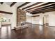 Living room with hardwood floors, wood beams, and stone fireplace at 3044 Ironwood Rd, Carefree, AZ 85377