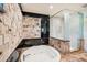 Spa-like bathroom featuring a large tub and glass shower enclosure at 3044 Ironwood Rd, Carefree, AZ 85377