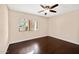 Bright bedroom with dark hardwood floors and ceiling fan at 3044 Ironwood Rd, Carefree, AZ 85377