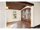 Elegant entryway with wood beams, arched windows, and tile floor at 3044 Ironwood Rd, Carefree, AZ 85377