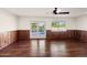 Gathering room with hardwood floors, wood paneling, and access to the pool at 3044 Ironwood Rd, Carefree, AZ 85377