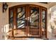 Ornate wooden double front doors with iron accents at 3044 Ironwood Rd, Carefree, AZ 85377