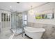 Spa-like bathroom with a walk-in shower, soaking tub, and marble finishes at 3044 Ironwood Rd, Carefree, AZ 85377