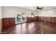 Gathering room with hardwood floors, wood paneling, and pool view at 3044 Ironwood Rd, Carefree, AZ 85377