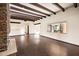 Bright living area with hardwood floors, wood beams, and large window at 3044 Ironwood Rd, Carefree, AZ 85377