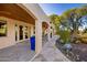 Charming stone patio with arched covered walkway, blue pots, and desert landscaping at 3044 Ironwood Rd, Carefree, AZ 85377
