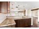 Kitchen island with granite countertop and dark wood cabinets at 3044 Ironwood Rd, Carefree, AZ 85377