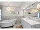 Elegant bathroom with marble tile, soaking tub, and modern vanity at 3044 Ironwood Rd, Carefree, AZ 85377